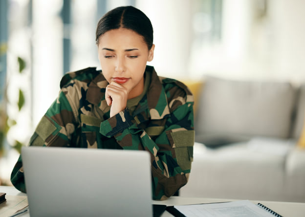 Woman in a military uniform taking the LPI assessment on a laptop.