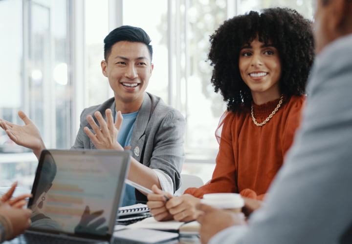 Group of smiling coworkers in a meeting.