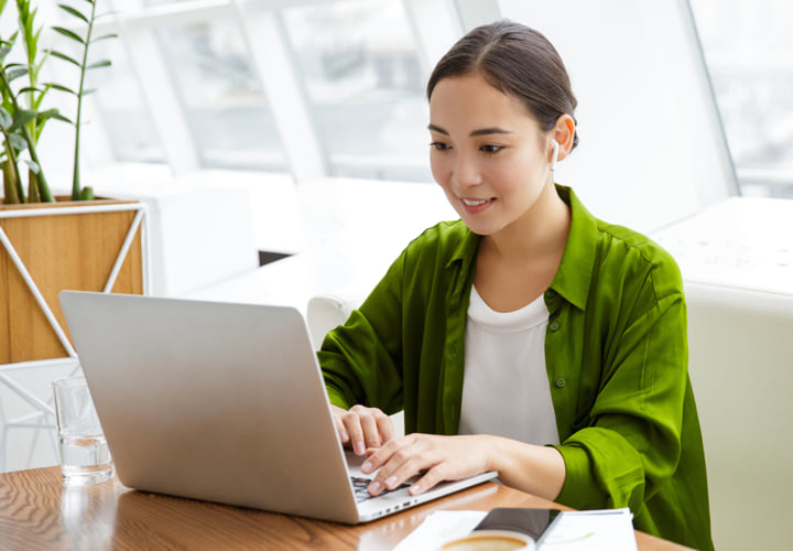 Young woman student working at a laptop.