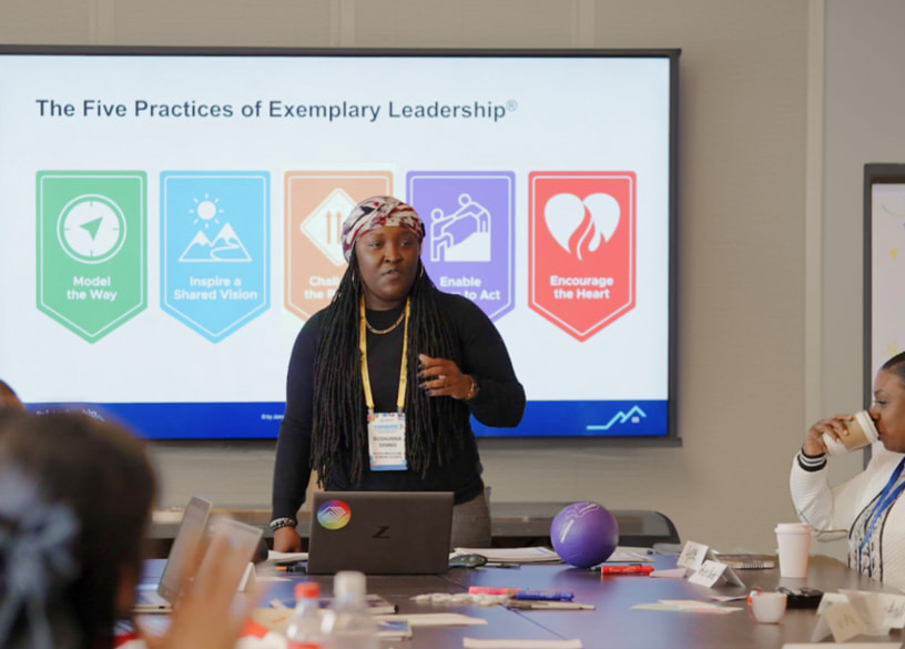 Woman standing and presenting The Five Practices of Exemplary Leadership.